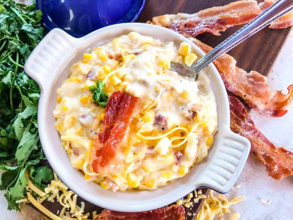 Cheddar Bacon Creamed Corn is a simple homemade creamed corn recipe perfect for a BBQ or Southern soul food meal. Corn is cooked with bacon, cheddar cheese, milk, and butter for a simple side dish. #creamedcorn #southernfood