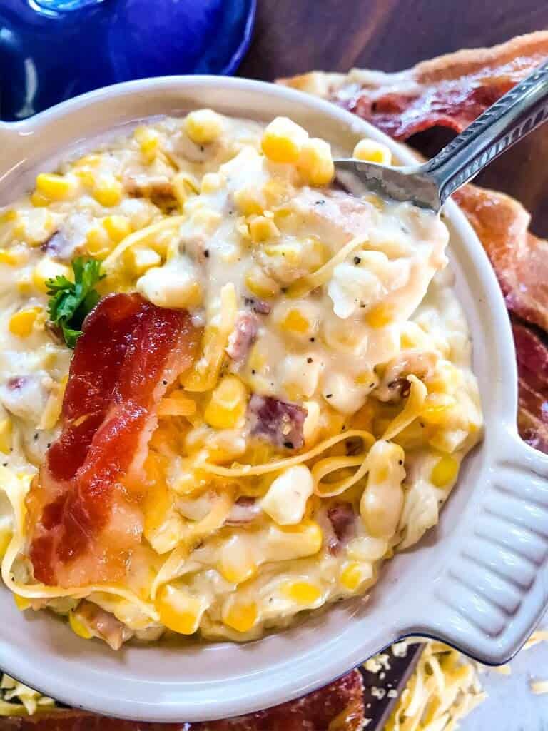Cheddar Bacon Creamed Corn is a simple homemade creamed corn recipe perfect for a BBQ or Southern soul food meal. Corn is cooked with bacon, cheddar cheese, milk, and butter for a simple side dish. #creamedcorn #southernfood