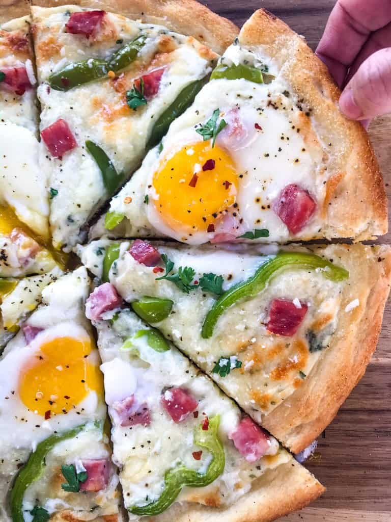 This Denver Omelet Pizza is ready in just 30 minutes using Fleischmann’s® RapidRise® Yeast, topped with a white sauce, ham, green bell peppers, and eggs. #HomemadePizzaCrust #homemadepizza