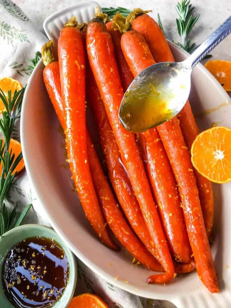 Orange Maple Glazed Carrots are a fast and simple side dish recipe ready in 20 minutes! Perfect for holiday dinners like Easter. Fresh and sweet flavors of orange and maple syrup in a simple sauce. Gluten free and vegan. #glazedcarrots #easterrecipes #sidedishrecipes