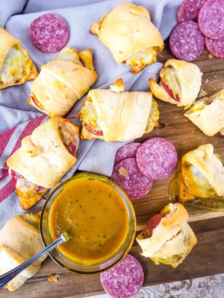 Cheesy Mustard Salami Crescent Rolls are filled with Margherita® Genoa Salami, cheese, and a simple mustard sauce served with more mustard sauce for dipping! An easy and fast appetizer recipe for party entertaining and game day or snack. #crescentrolls #salami #appetizerrecipes