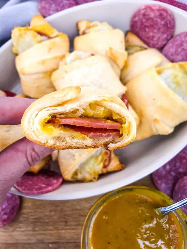 Cheesy Mustard Salami Crescent Rolls are filled with Margherita® Genoa Salami, cheese, and a simple mustard sauce served with more mustard sauce for dipping! An easy and fast appetizer recipe for party entertaining and game day or snack. #crescentrolls #salami #appetizerrecipes