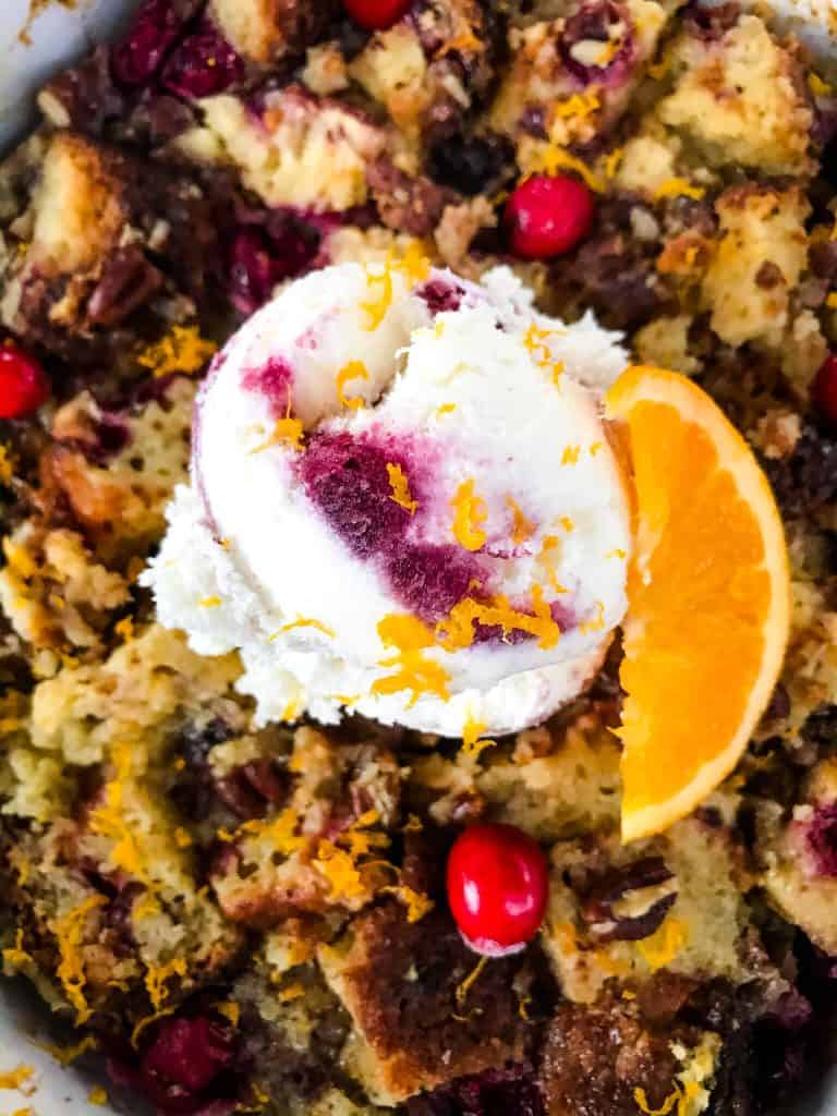 Cranberry Orange Bread Pudding is a delicious bread pudding recipe full of fresh orange and cranberries. Make in advance and serve up with ice cream for a special event or holiday dessert. #breadpudding #cranberryorange #holidaydessert
