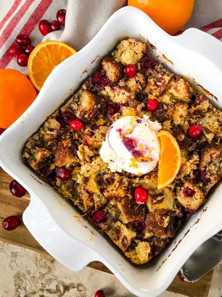 Cranberry Orange Bread Pudding is a delicious bread pudding recipe full of fresh orange and cranberries. Make in advance and serve up with ice cream for a special event or holiday dessert. #breadpudding #cranberryorange #holidaydessert