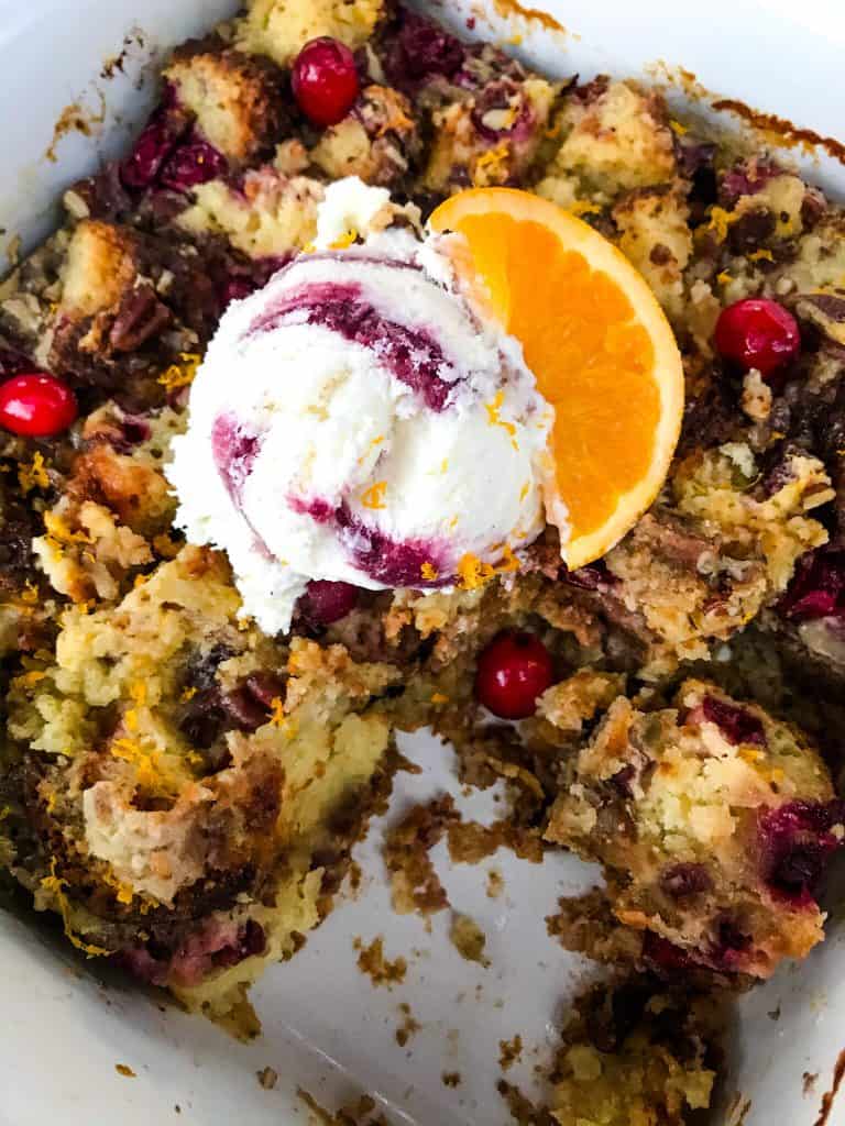 Cranberry Orange Bread Pudding is a delicious bread pudding recipe full of fresh orange and cranberries. Make in advance and serve up with ice cream for a special event or holiday dessert. #breadpudding #cranberryorange #holidaydessert