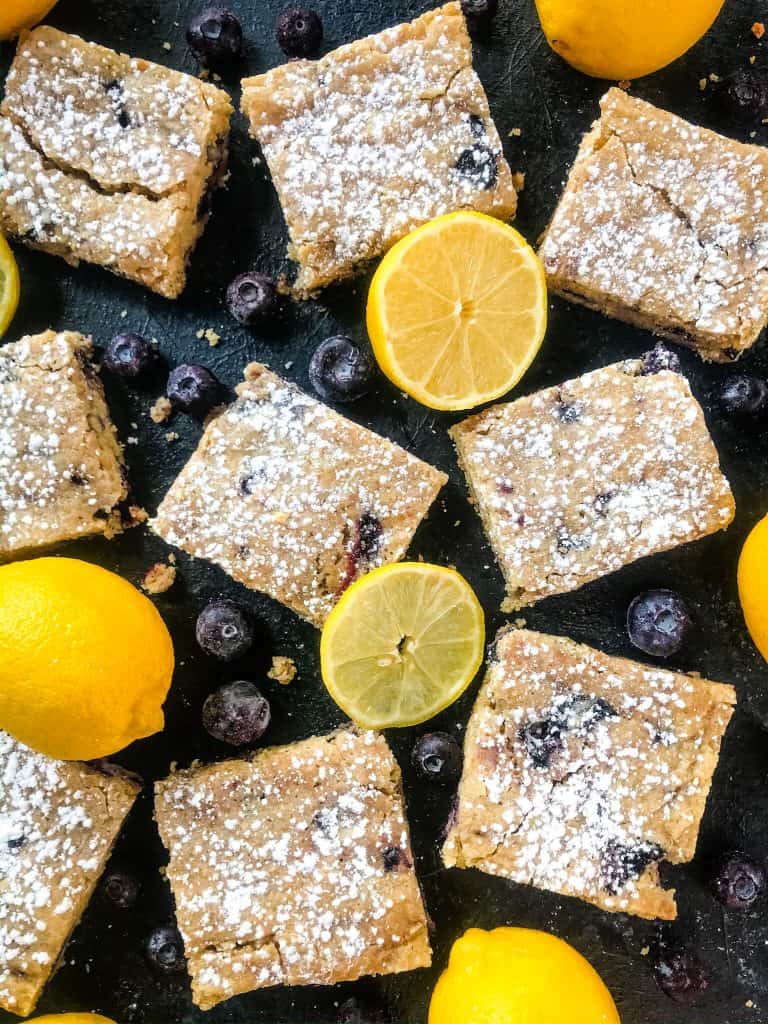 Lemon Blueberry Blondie Recipe is a cross between soft cookie bar and brownie filled with fresh blueberries and lemon. A great spring dessert. #blondies #blueberrylemon