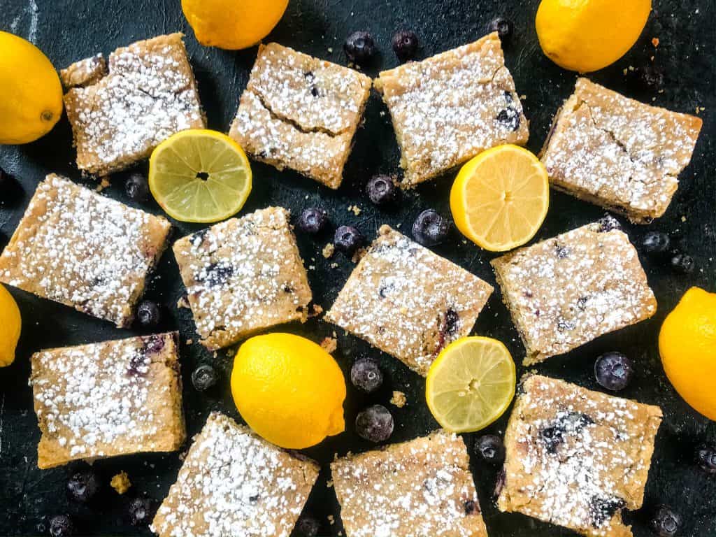 Lemon Blueberry Blondie Recipe is a cross between soft cookie bar and brownie filled with fresh blueberries and lemon. A great spring dessert. #blondies #blueberrylemon