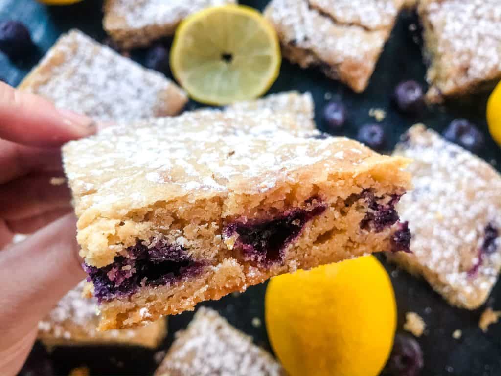 Lemon Blueberry Blondie Recipe is a cross between soft cookie bar and brownie filled with fresh blueberries and lemon. A great spring dessert. #blondies #blueberrylemon