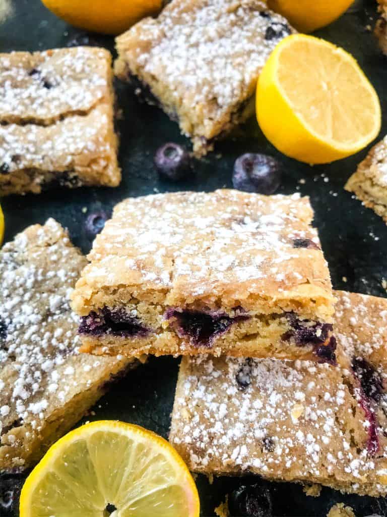Lemon Blueberry Blondie Recipe is a cross between soft cookie bar and brownie filled with fresh blueberries and lemon. A great spring dessert. #blondies #blueberrylemon