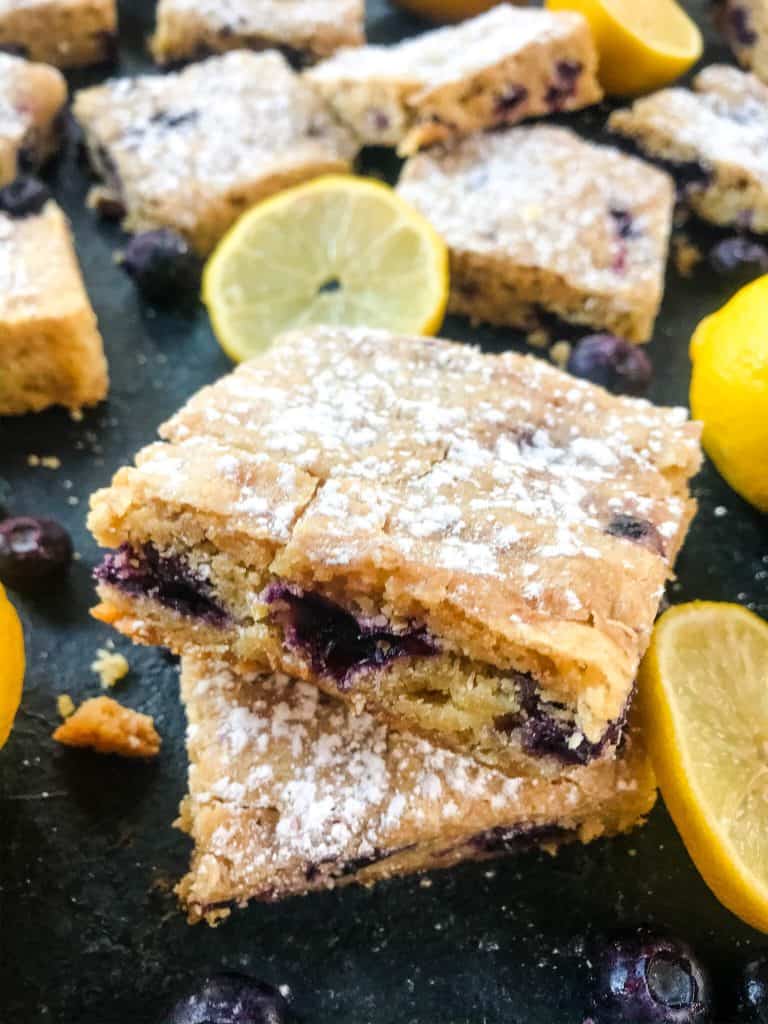 Lemon Blueberry Blondie Recipe is a cross between soft cookie bar and brownie filled with fresh blueberries and lemon. A great spring dessert. #blondies #blueberrylemon