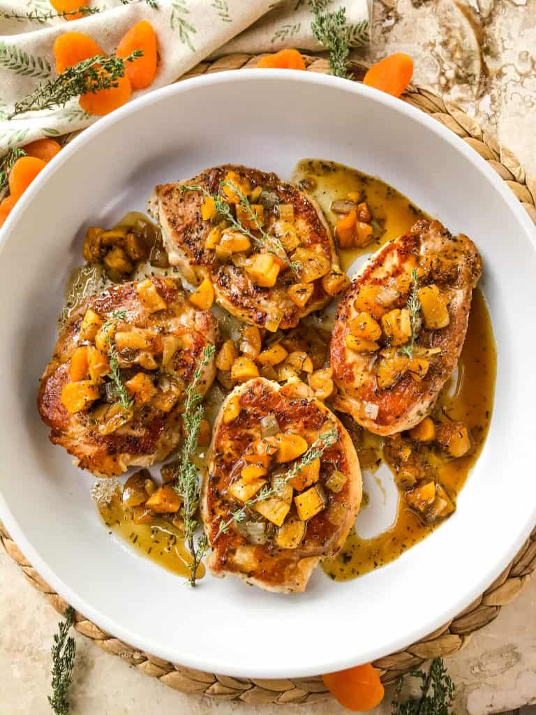 Stove top Bourbon Apricot Pork Chops recipe is a fast weeknight dinner made in one pot. A pan sauce of bourbon and dried apricots with seared pork served with rice, potatoes, or vegetables. Gluten free and dairy free, ready in 30 minutes. Easy pan seared pork chops. #porkchops #stovetopporkchops