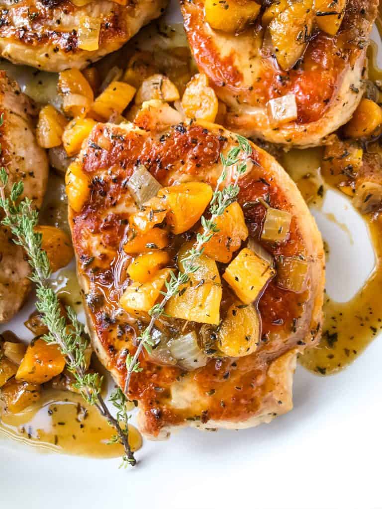 Stove top Bourbon Apricot Pork Chops recipe is a fast weeknight dinner made in one pot. A pan sauce of bourbon and dried apricots with seared pork served with rice, potatoes, or vegetables. Gluten free and dairy free, ready in 30 minutes. Easy pan seared pork chops. #porkchops #stovetopporkchops