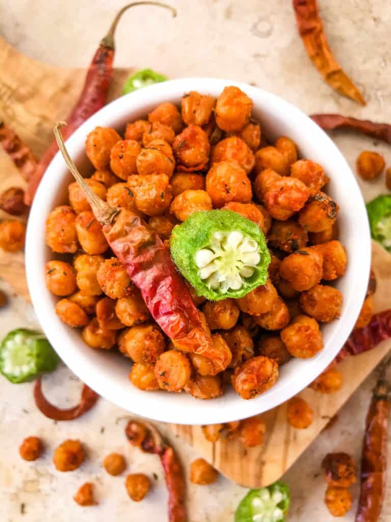 Cajun Roasted Chickpeas are a simple and easy spicy snack recipe. Vegetarian, vegan, gluten free, dairy free. Cajun spices flavor these crunchy garbanzo beans. Great for Mardi Gras, game day, appetizers, parties, and snacks. #roastedchickpeas #healthysnack #cajun