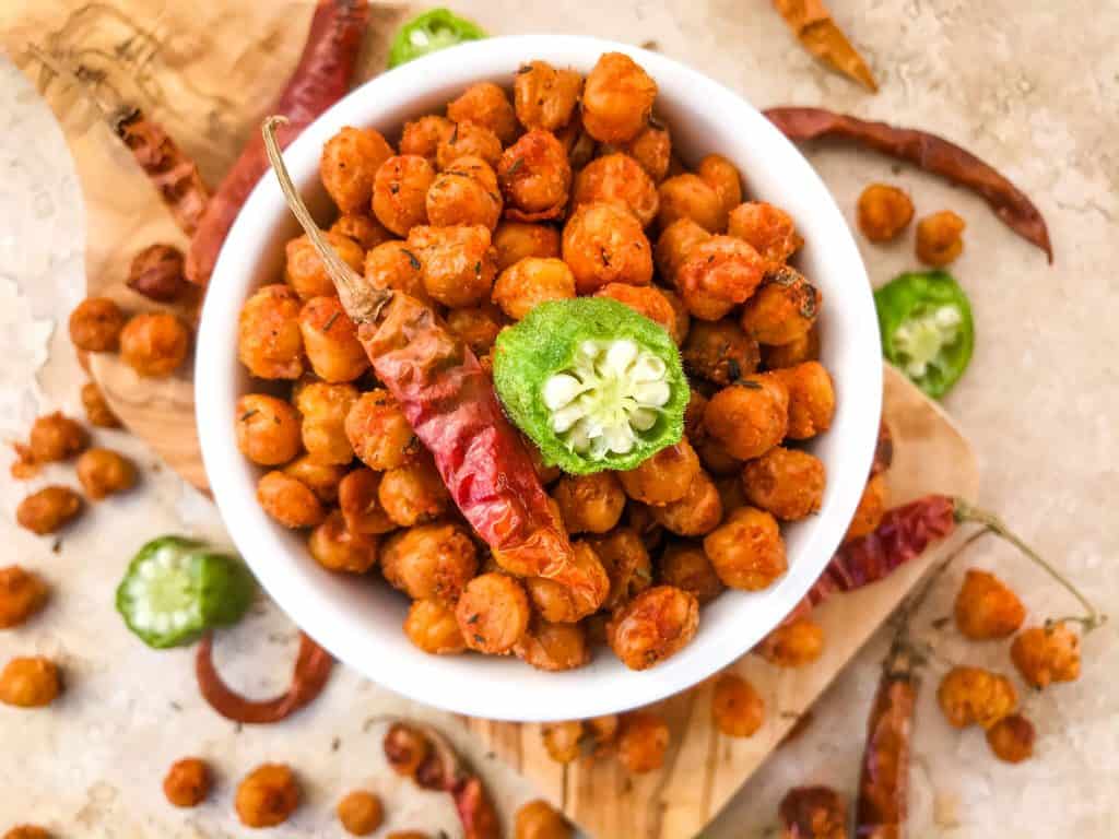 Cajun Roasted Chickpeas are a simple and easy spicy snack recipe. Vegetarian, vegan, gluten free, dairy free. Cajun spices flavor these crunchy garbanzo beans. Great for Mardi Gras, game day, appetizers, parties, and snacks. #roastedchickpeas #healthysnack #cajun