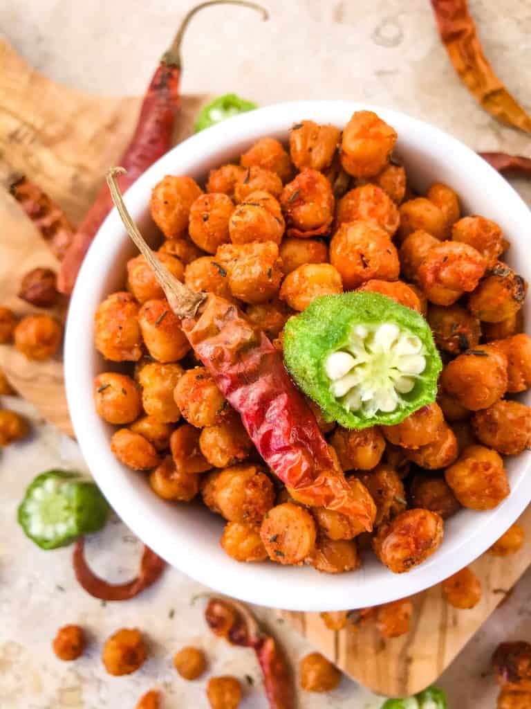 Cajun Roasted Chickpeas are a simple and easy spicy snack recipe. Vegetarian, vegan, gluten free, dairy free. Cajun spices flavor these crunchy garbanzo beans. Great for Mardi Gras, game day, appetizers, parties, and snacks. #roastedchickpeas #healthysnack #cajun