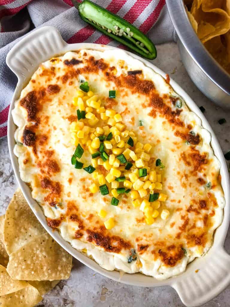 Warm Corn Cheese Dip is packed with three cheeses and corn for a fast and easy appetizer recipe. It takes just minutes to make this vegetarian and gluten free corn dip for a party, game day, or holiday appetizer. #corndip #cheesedip