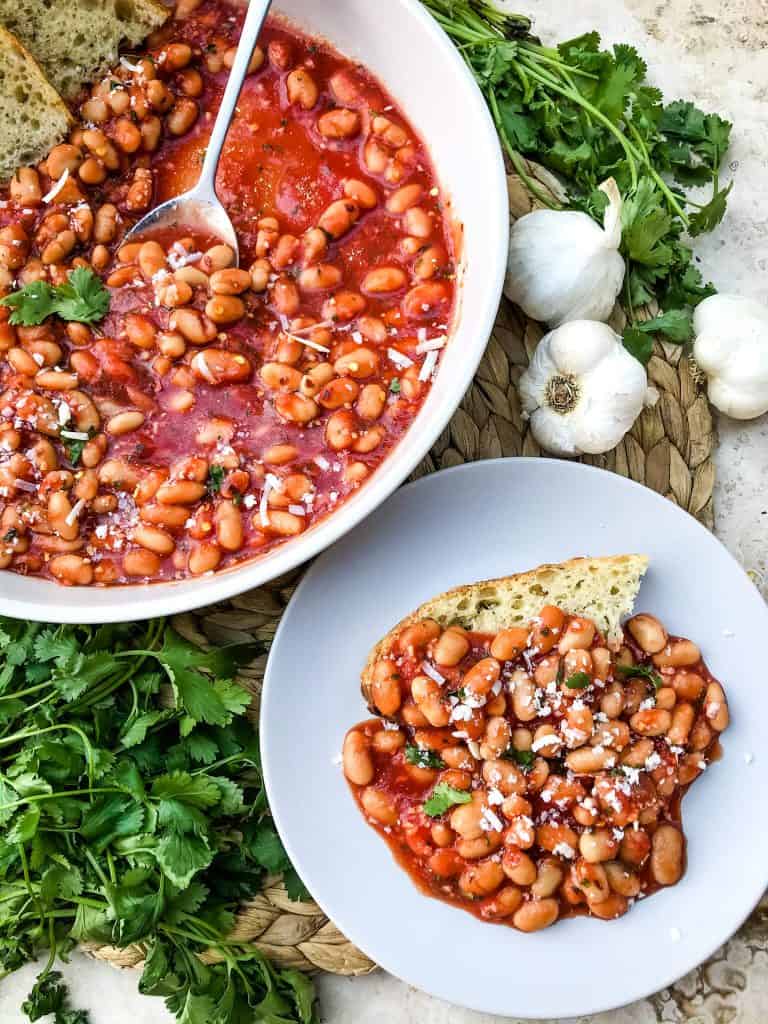 Arrabbiata Beans (Spicy Italian Beans) are based on the classic Italian pasta recipe. A spicy tomato sauce filled with garlic and crushed red pepper flakes with white beans. Vegan and gluten free pantry recipe. #beanrecipes #spicyItalian #Italianbeans