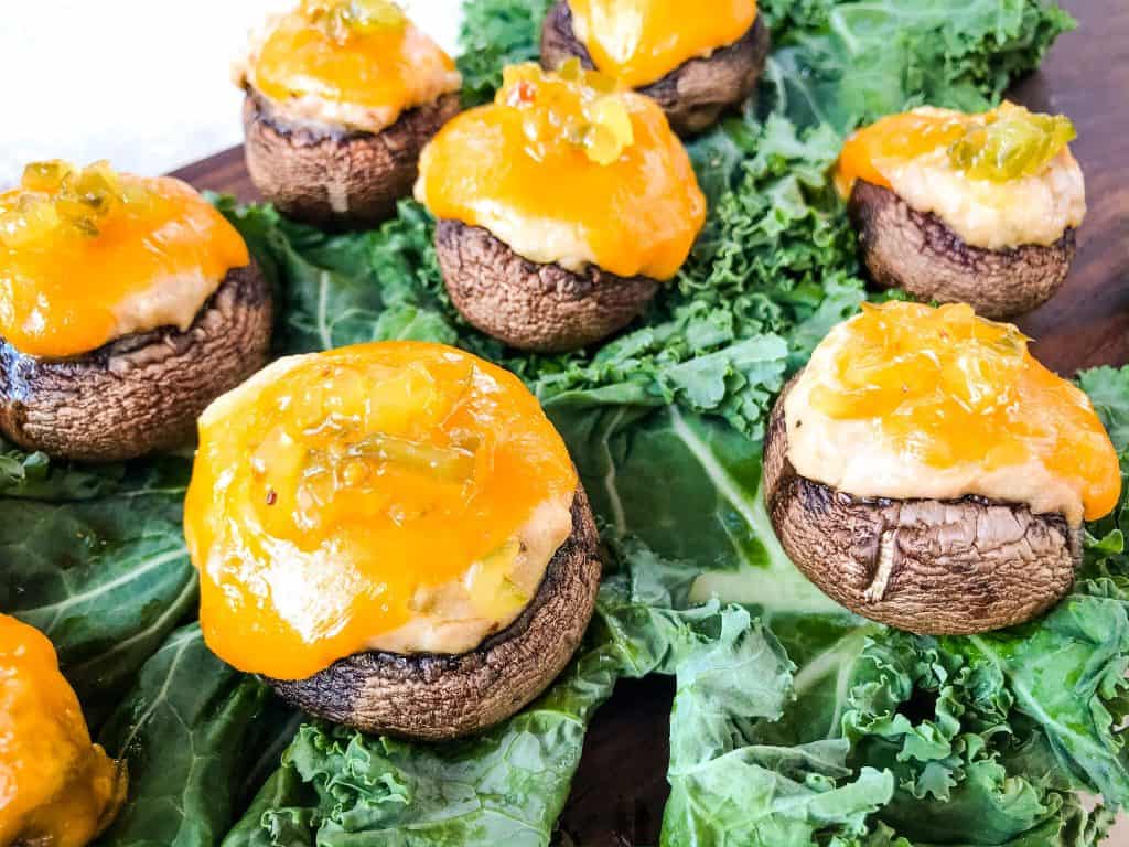 Tuna Melt Stuffed Mushrooms sitting on lettuce