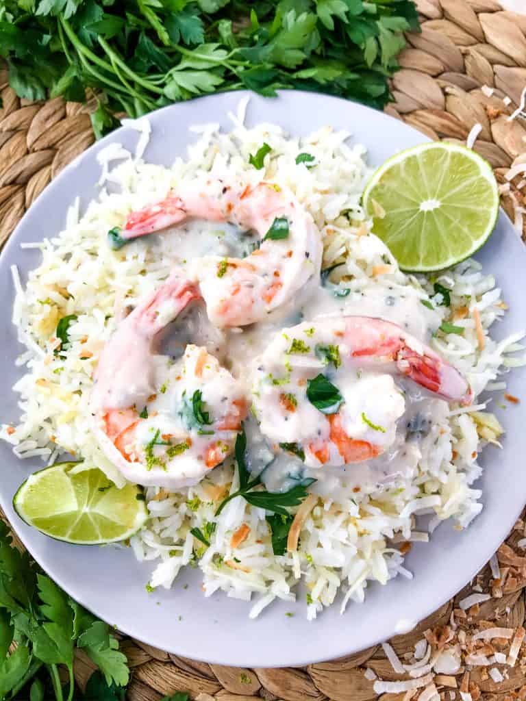 Coconut Lime Rice is a tropical side dish recipe made with coconut milk, toasted coconut flakes, and fresh lime. Vegan, vegetarian, and gluten free. Also can be made in a rice cooker or Instant Pot. #coconutrice #coconutlime #ricerecipes