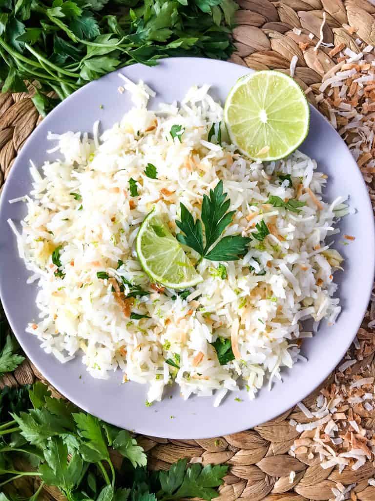 Coconut Lime Rice is a tropical side dish recipe made with coconut milk, toasted coconut flakes, and fresh lime. Vegan, vegetarian, and gluten free. Also can be made in a rice cooker or Instant Pot. #coconutrice #coconutlime #ricerecipes