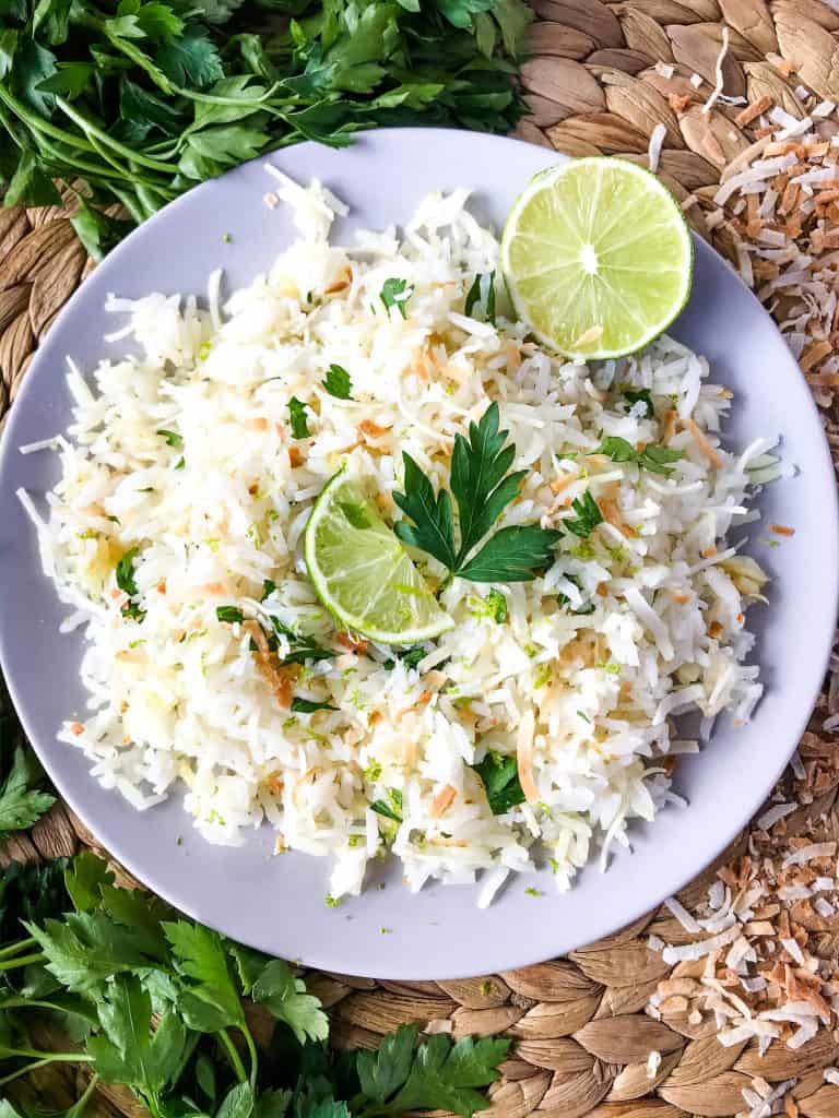 Coconut Lime Rice is a tropical side dish recipe made with coconut milk, toasted coconut flakes, and fresh lime. Vegan, vegetarian, and gluten free. Also can be made in a rice cooker or Instant Pot. #coconutrice #coconutlime #ricerecipes