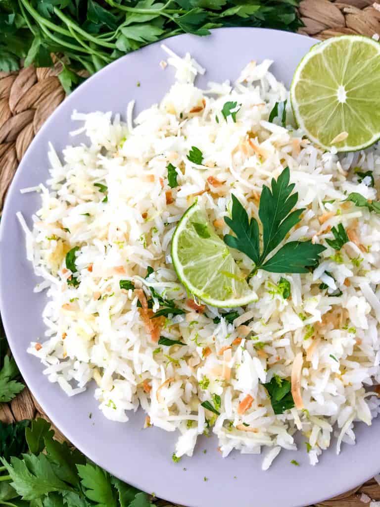 Coconut Lime Rice is a tropical side dish recipe made with coconut milk, toasted coconut flakes, and fresh lime. Vegan, vegetarian, and gluten free. Also can be made in a rice cooker or Instant Pot. #coconutrice #coconutlime #ricerecipes