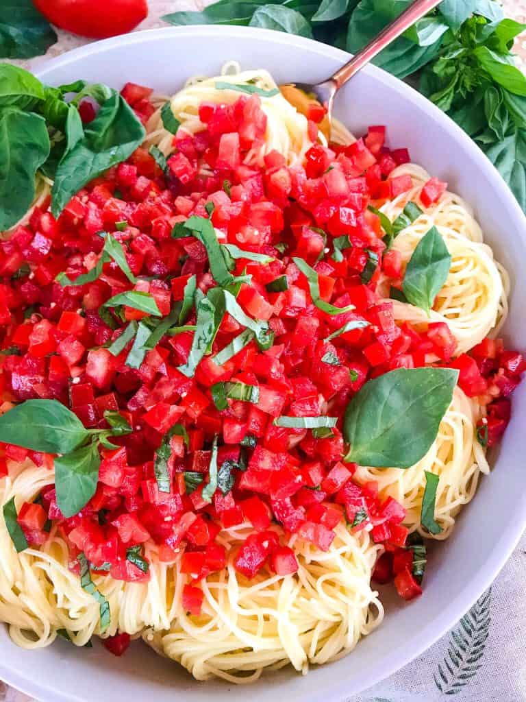 Copycat Olive Garden Capellini Pomodoro is a fresh, easy tomato basil pasta. Fresh tomatoes and basil on angel hair pasta to replicate the vegan Italian pasta restaurant recipes. #olivegardenrecipes #copycat #tomatopasta #tomatobasil