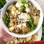 Pin of a hand holding a white bowl full of Copycat Olive Garden Zuppa Toscana with title