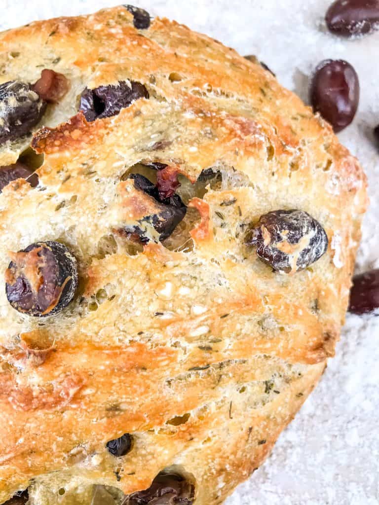 Top of a full loaf of olive bread