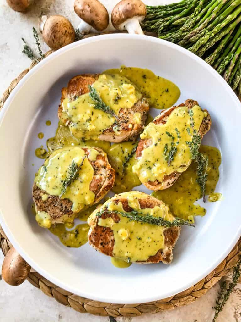 Get these Creamy Honey Mustard Pork Chops on the table in just 30 minutes! Pan seared pork chops are topped with a simple honey mustard pan sauce. Gluten free. Serve with rice, potatoes, or vegetables. #honeymustard #porkchops #30minutemeals