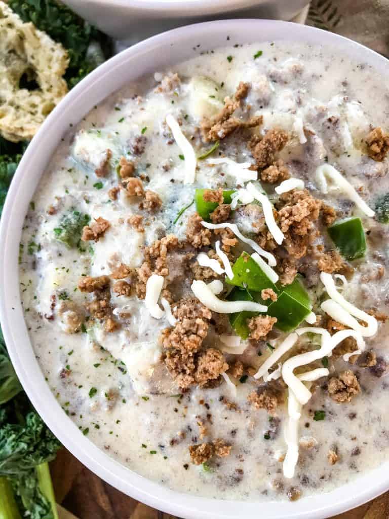 A close up bowl of Philly Cheesesteak Soup with beef, peppers, and cheese