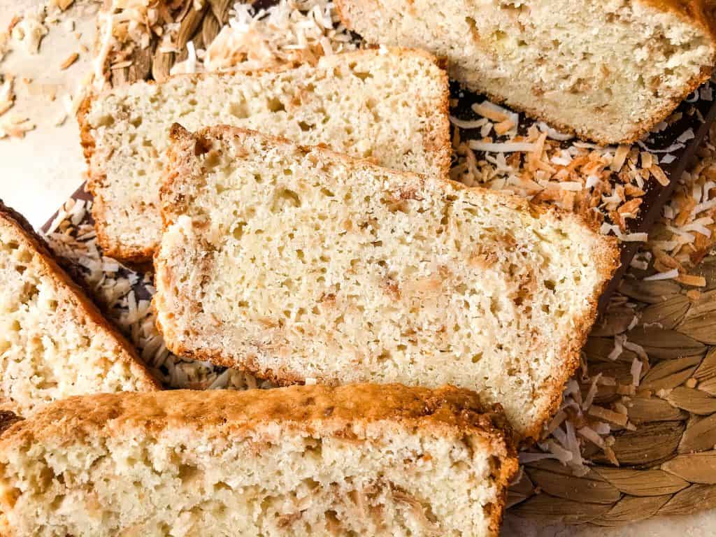 This Quick Coconut Bread recipe is easy to make and vegan! Full of coconut milk, coconut oil, and toasted shredded coconut. #veganbread #coconut #quickbread