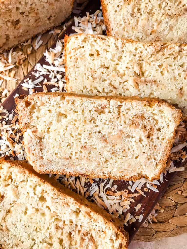 This Quick Coconut Bread recipe is easy to make and vegan! Full of coconut milk, coconut oil, and toasted shredded coconut. #veganbread #coconut #quickbread