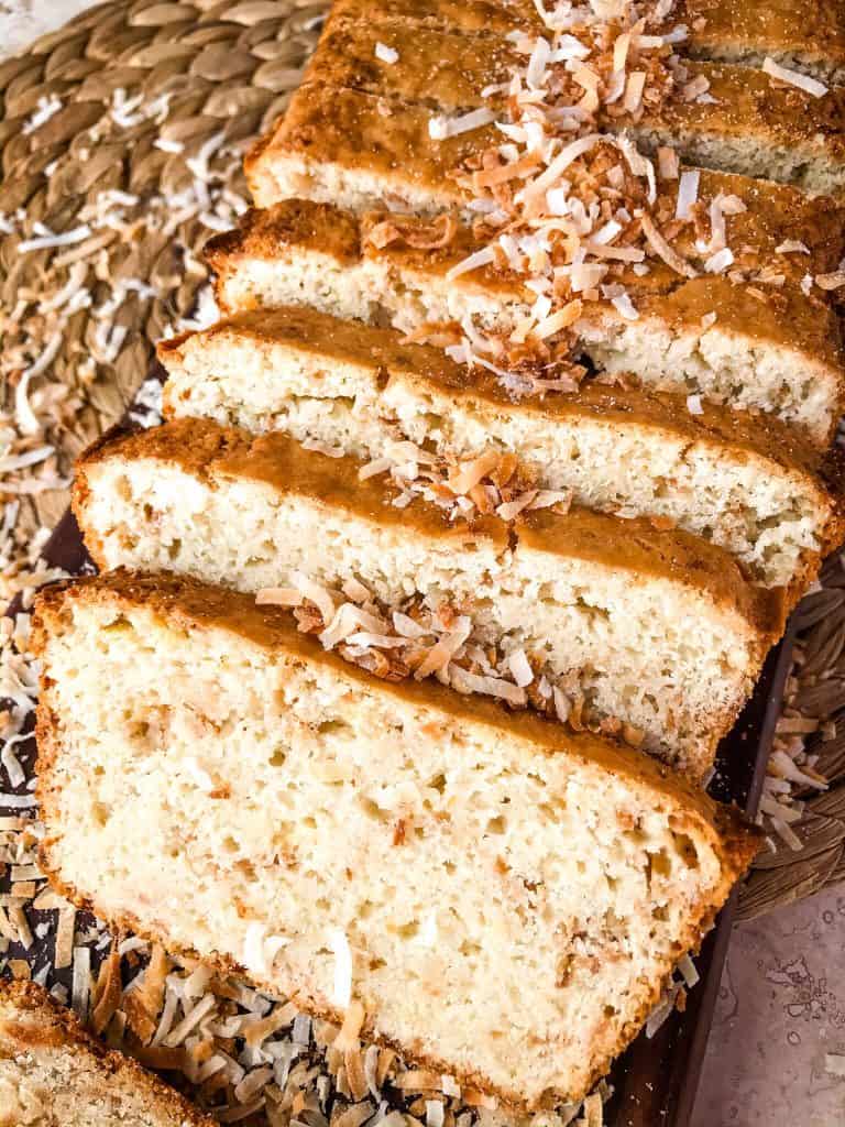 This Quick Coconut Bread recipe is easy to make and vegan! Full of coconut milk, coconut oil, and toasted shredded coconut. #veganbread #coconut #quickbread