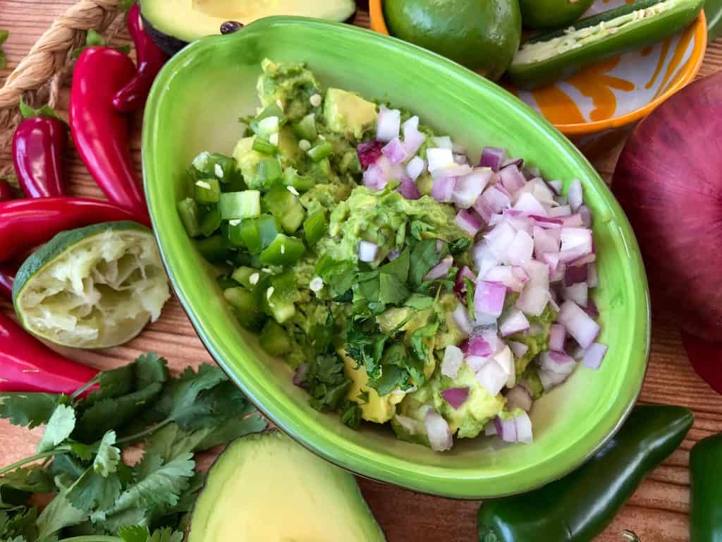 Copycat Chipotle Guacamole just like the Mexican restaurant! Avocado is mixed with jalapeno pepper, lime, red onion, and cilantro. A fast and easy appetizer dip or Mexican condiment. #copycatrecipes #chipotleguacamole #avocado