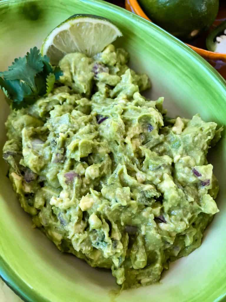 Copycat Chipotle Guacamole just like the Mexican restaurant! Avocado is mixed with jalapeno pepper, lime, red onion, and cilantro. A fast and easy appetizer dip or Mexican condiment. #copycatrecipes #chipotleguacamole #avocado