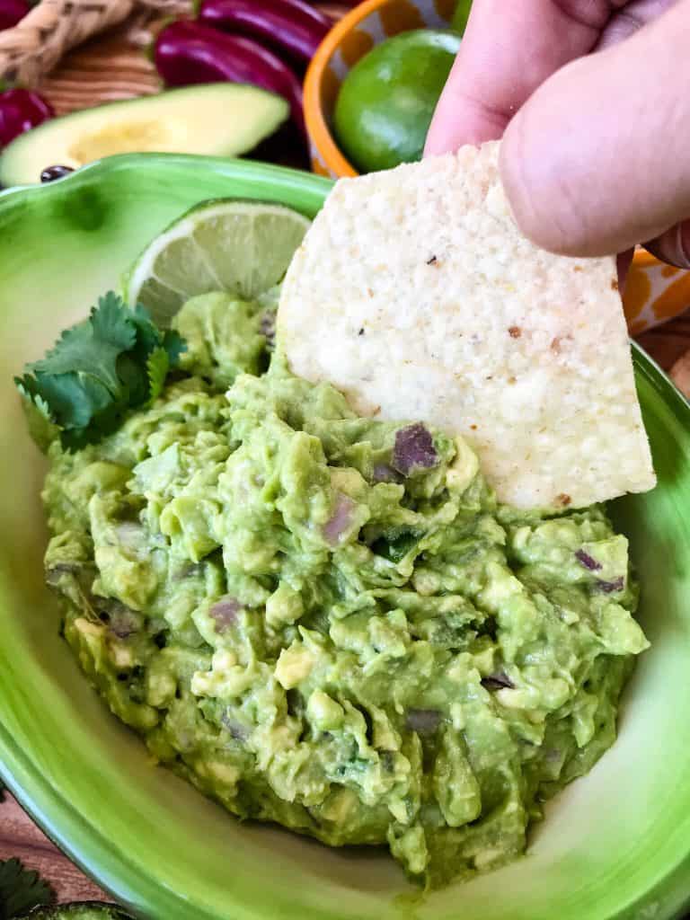 Copycat Chipotle Guacamole just like the Mexican restaurant! Avocado is mixed with jalapeno pepper, lime, red onion, and cilantro. A fast and easy appetizer dip or Mexican condiment. #copycatrecipes #chipotleguacamole #avocado