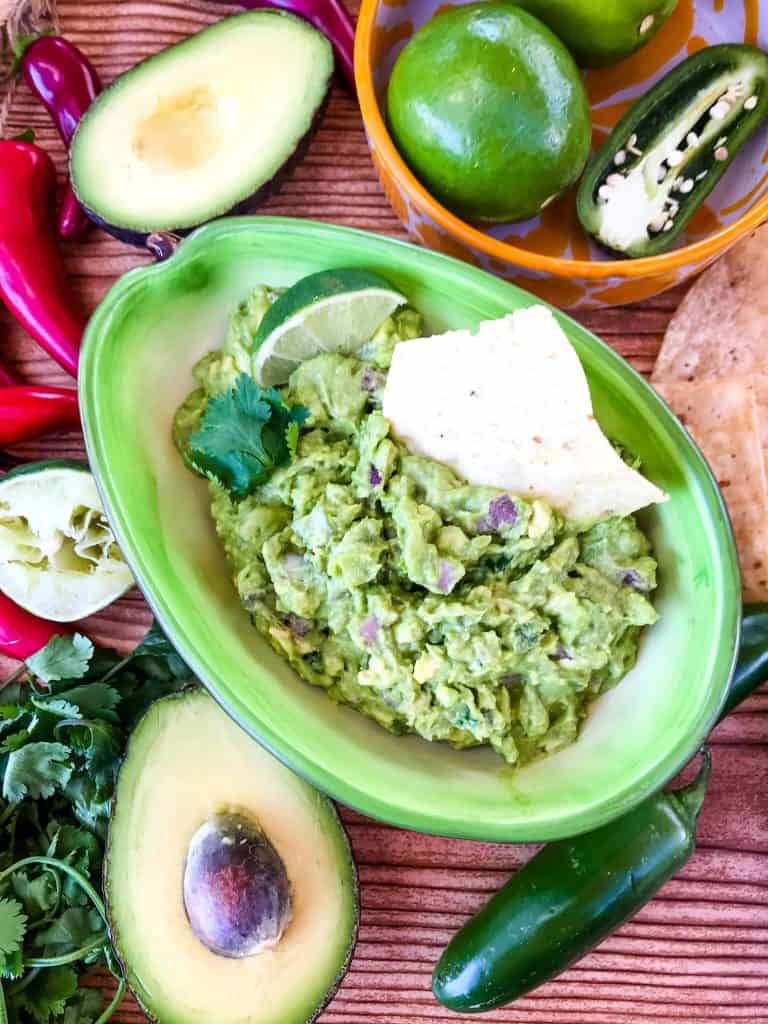 Copycat Chipotle Guacamole just like the Mexican restaurant! Avocado is mixed with jalapeno pepper, lime, red onion, and cilantro. A fast and easy appetizer dip or Mexican condiment. #copycatrecipes #chipotleguacamole #avocado