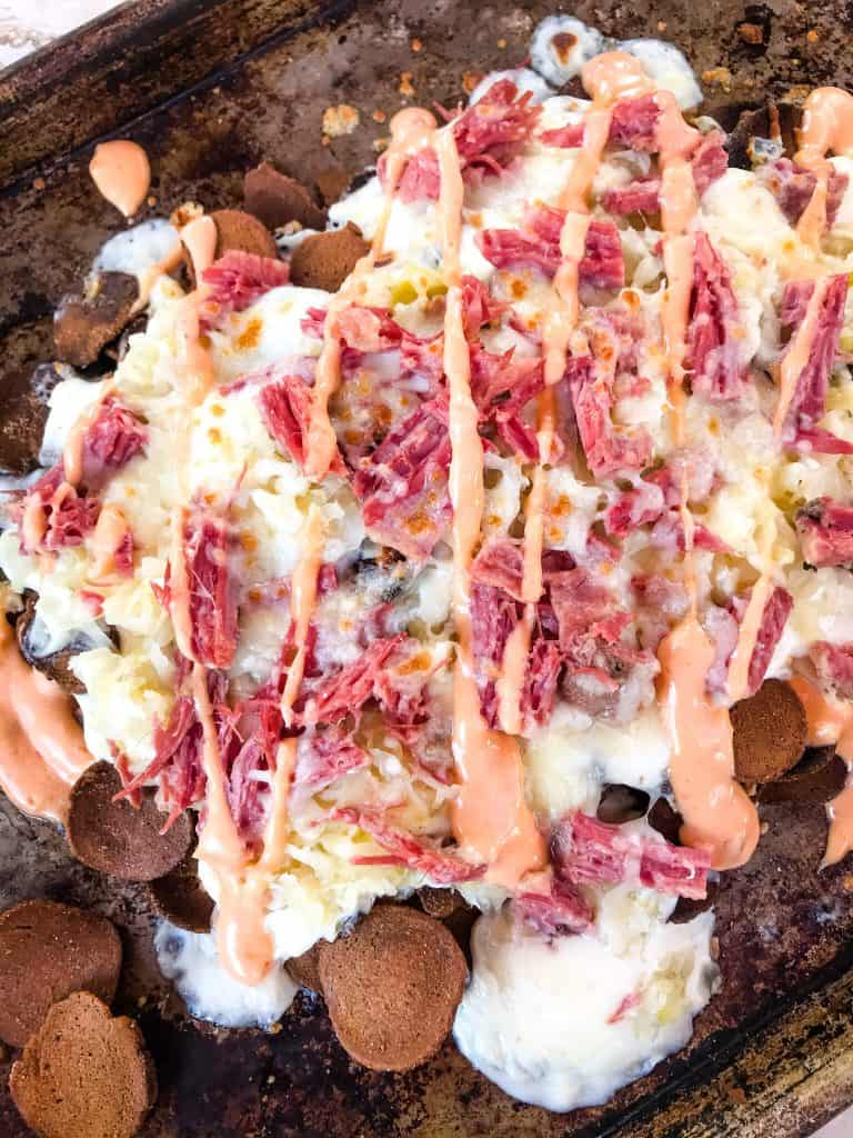 A pile of Reuben Irish Nachos from the top on a baking sheet