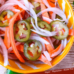 Pin top view of Escabeche (Mexican Pickled Vegetables) in a yellow bowl with title