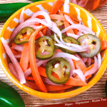 Pin of Escabeche (Mexican Pickled Vegetables) in a yellow bowl with title at bottom