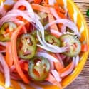 Top view of Escabeche (Mexican Pickled Vegetables) in a yellow bowl