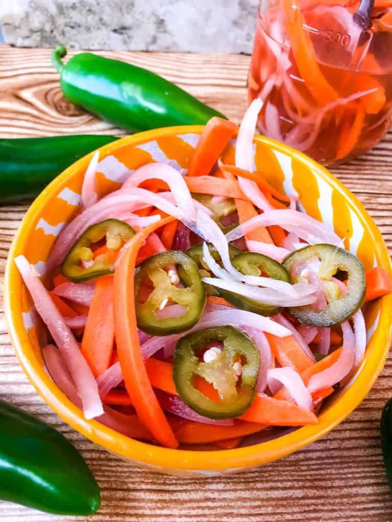 Homemade Escabeche (Mexican Pickled Vegetables) is a quick pickle recipe made with jalapeno peppers, carrot, and red onion. A gluten free and vegan refrigerator pickle that makes a great condiment. #escabeche #mexicanpickles #quickpickle #refrigeratorpickle