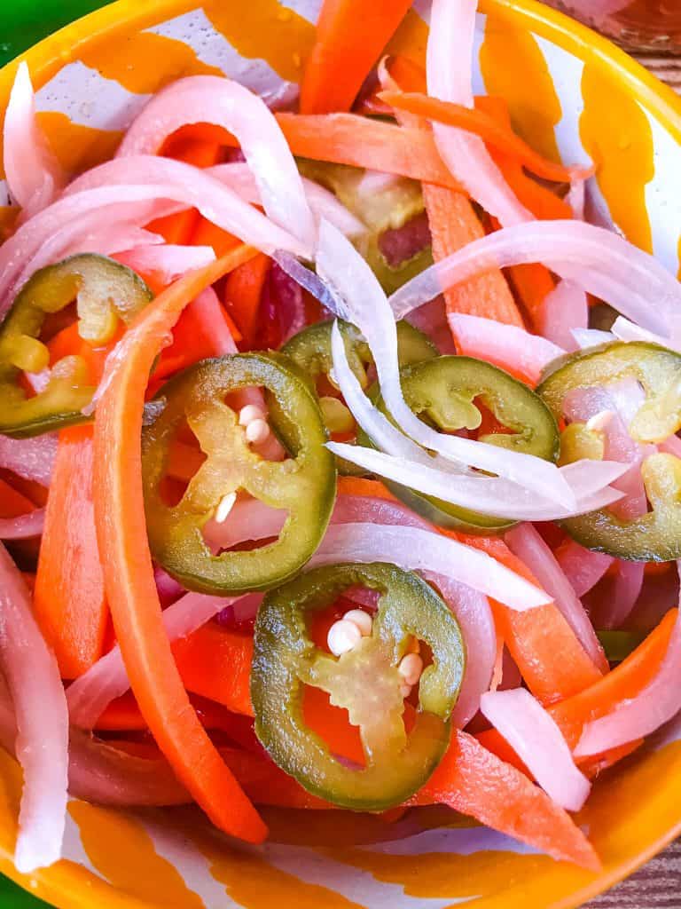 Homemade Escabeche (Mexican Pickled Vegetables) is a quick pickle recipe made with jalapeno peppers, carrot, and red onion. A gluten free and vegan refrigerator pickle that makes a great condiment. #escabeche #mexicanpickles #quickpickle #refrigeratorpickle