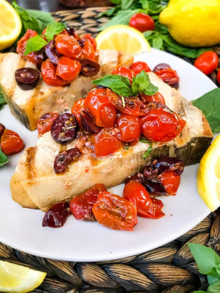 Grilled Swordfish Steaks with Tomato Olive Relish on a plate