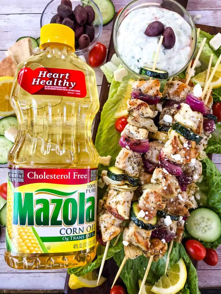 Fresh and Light Grilled Greek Chicken Skewers are a quick chicken grilling recipe for the BBQ! Chicken marinated in oil, oregano, and lemon on a kebab with onion, artichoke, and fresh Greek ingredients. Fast chicken kabob on the grill. #grilledchicken #chickenkabobs #greekchicken
