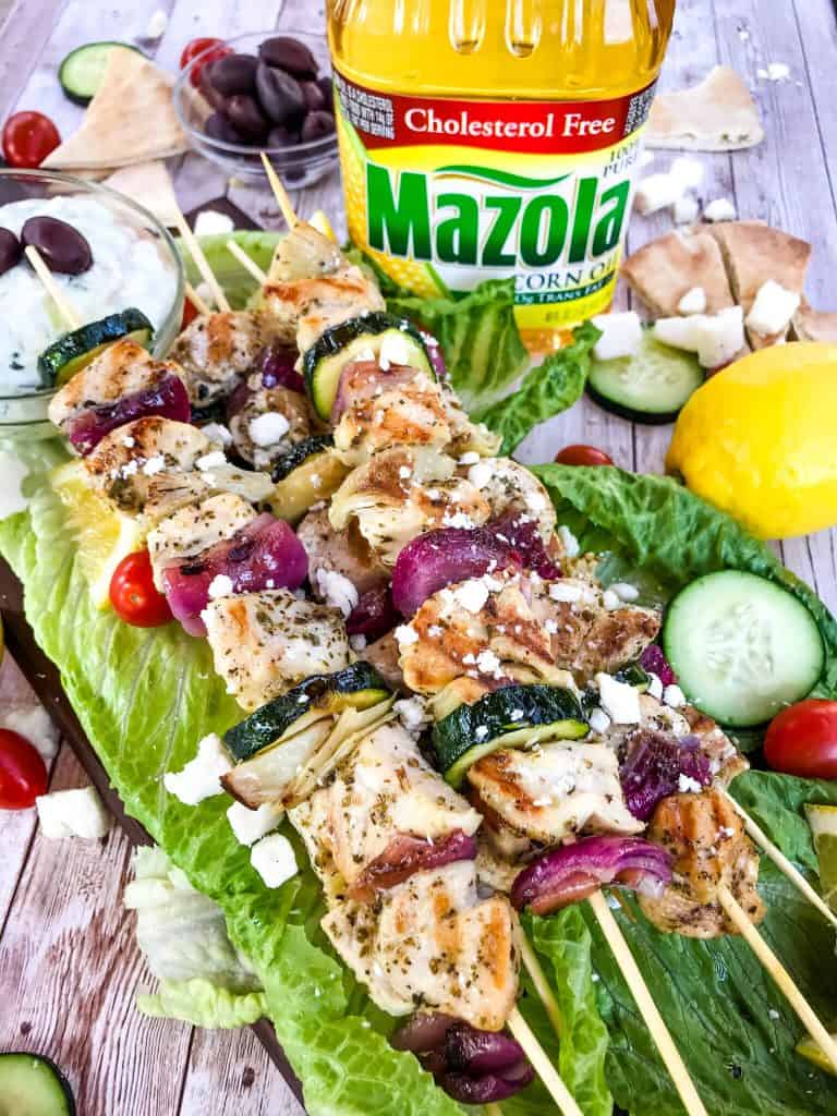 Fresh and Light Grilled Greek Chicken Skewers are a quick chicken grilling recipe for the BBQ! Chicken marinated in oil, oregano, and lemon on a kebab with onion, artichoke, and fresh Greek ingredients. Fast chicken kabob on the grill. #grilledchicken #chickenkabobs #greekchicken