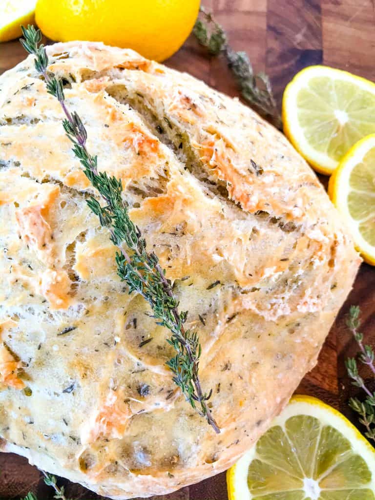 No Knead Rustic Lemon Thyme Bread is a simple homemade bread recipe. No knead and cooked in a Dutch oven, full of Italian flavors with lemon and dried herbs. #rusticbread #nokneadbread #Italianbread