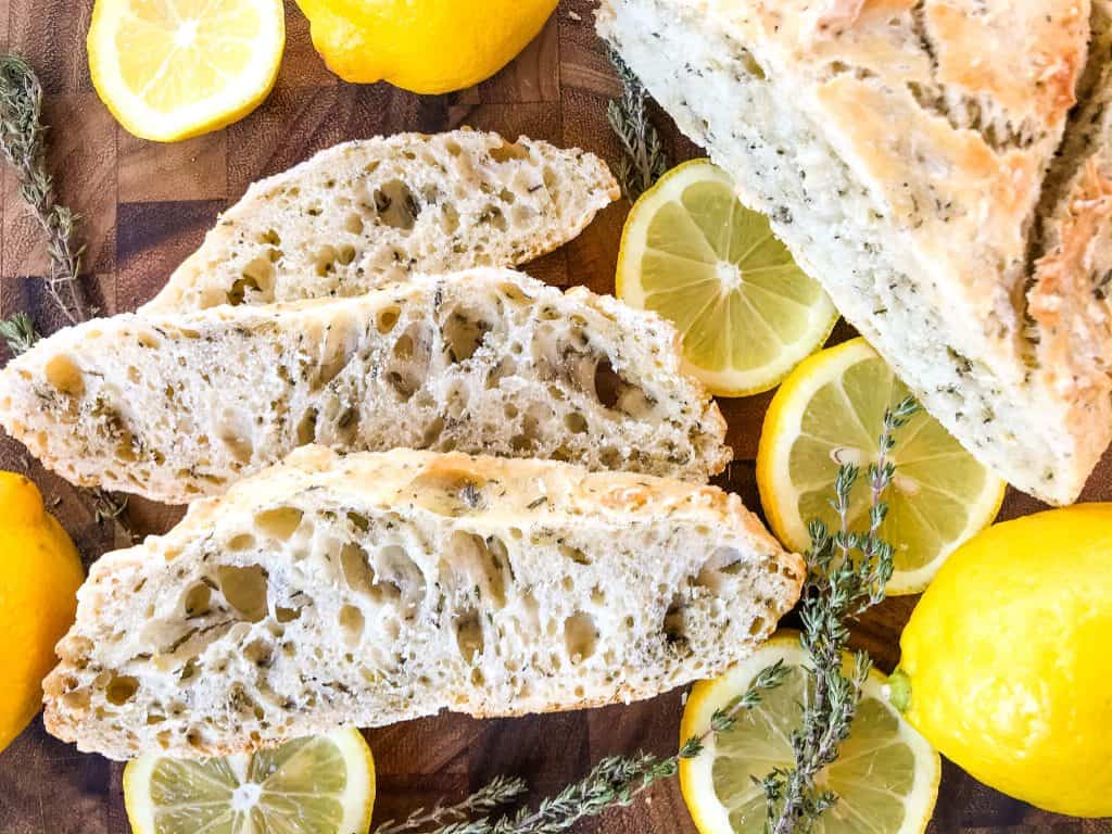 No Knead Rustic Lemon Thyme Bread is a simple homemade bread recipe. No knead and cooked in a Dutch oven, full of Italian flavors with lemon and dried herbs. #rusticbread #nokneadbread #Italianbread