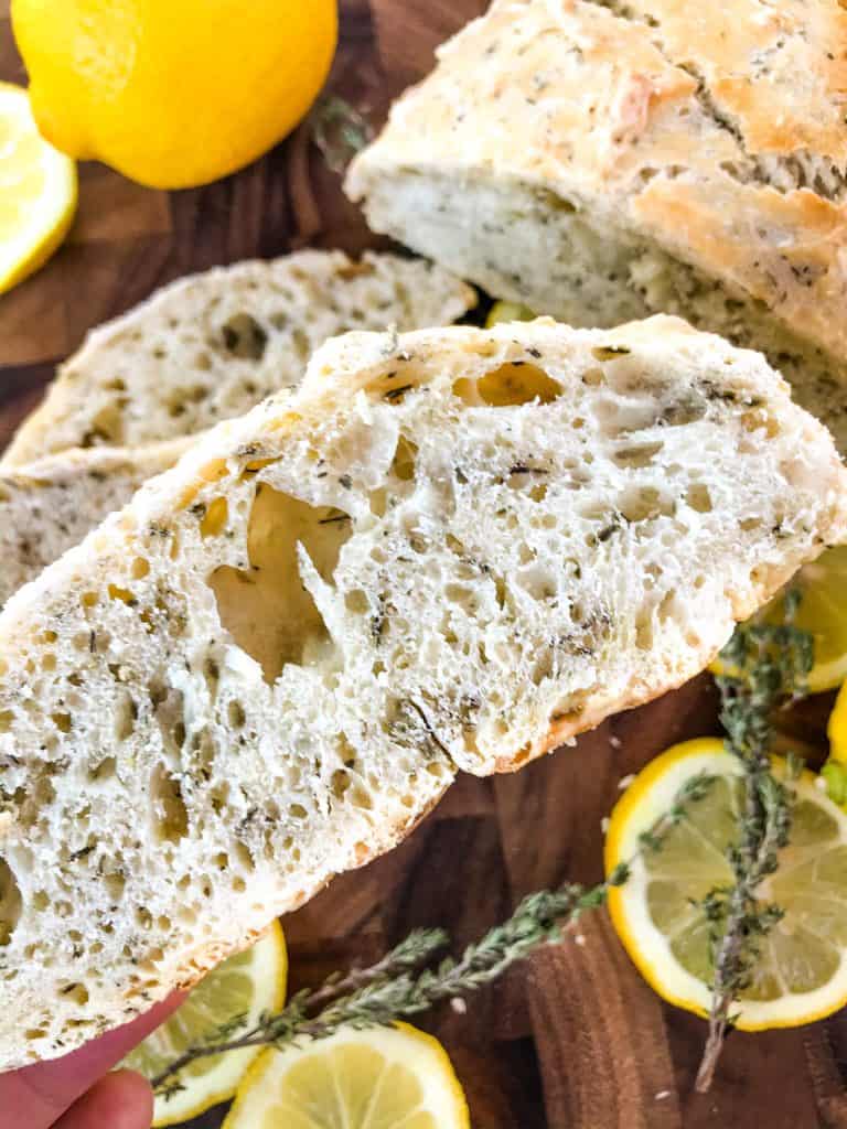 No Knead Rustic Lemon Thyme Bread is a simple homemade bread recipe. No knead and cooked in a Dutch oven, full of Italian flavors with lemon and dried herbs. #rusticbread #nokneadbread #Italianbread